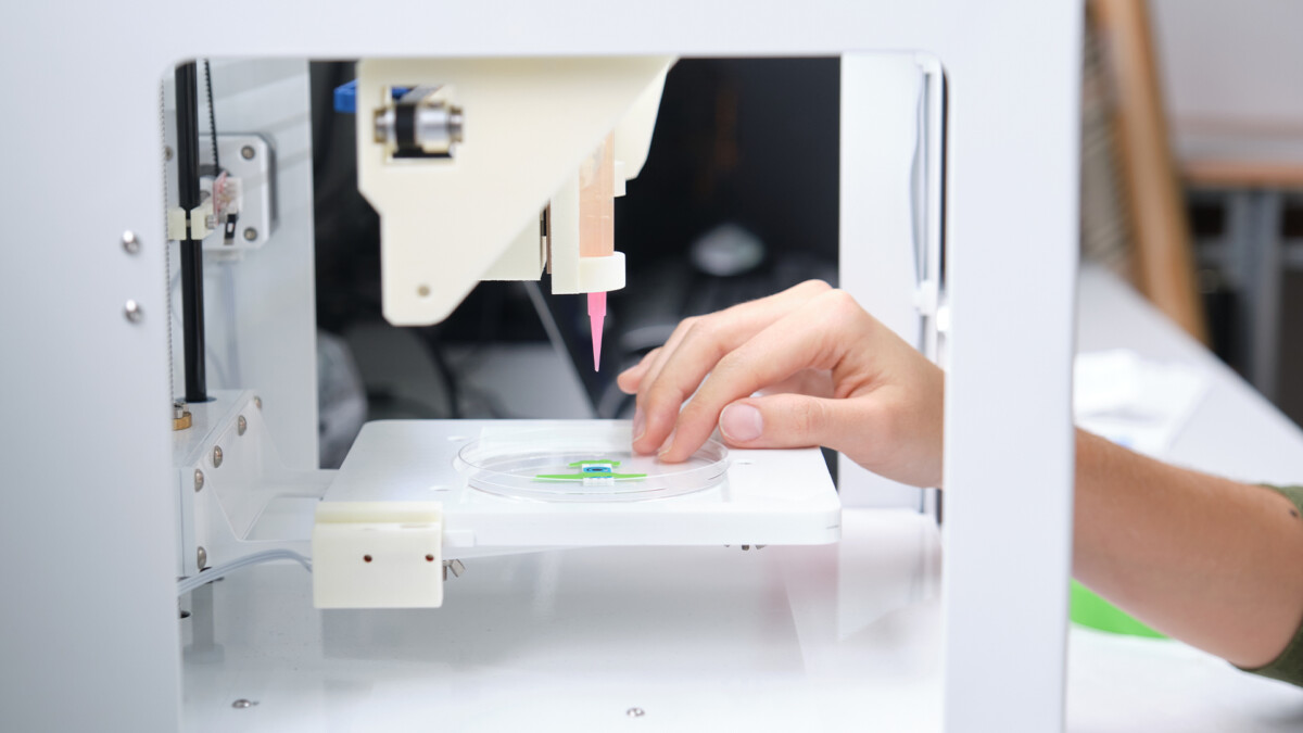 Researcher getting 3D bioprinter ready to 3D print cells onto an electrode